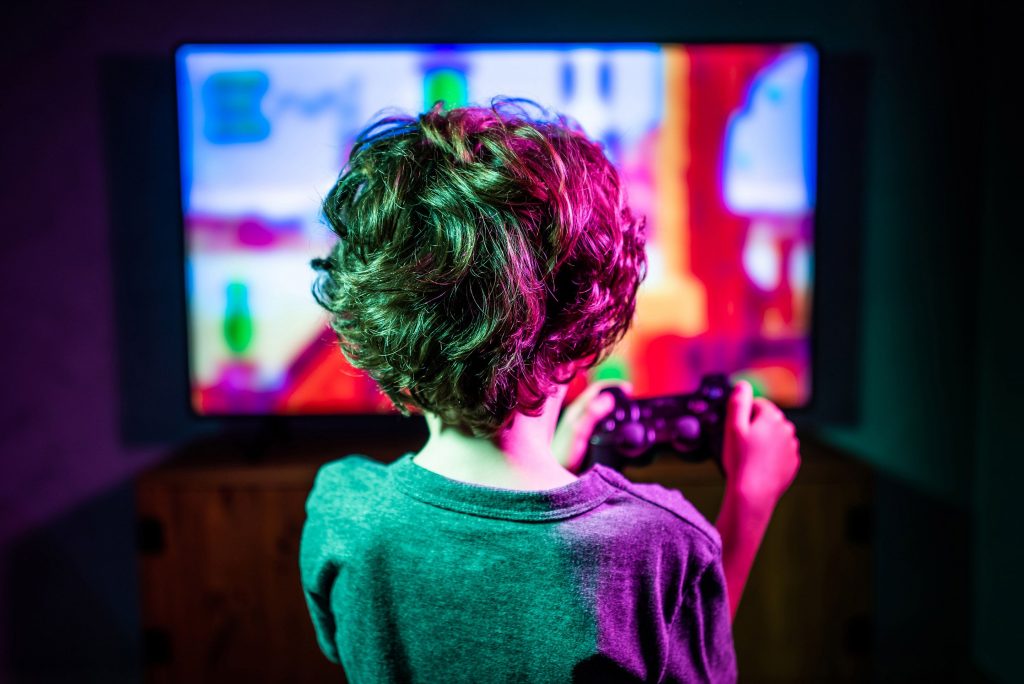 Devant son moniteur, ce jeune garçon dyslexique découvre les bienfaits des jeux vidéo.