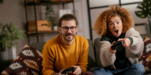 Un couple âgé de plus de 45 ans en train de jouer à des jeux vidéo